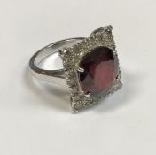 An 18 carat white gold mounted rectangular ladies dress ring set with oval cut garnet,