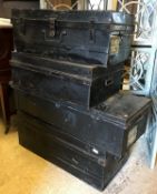 Four various black painted tin trunks
