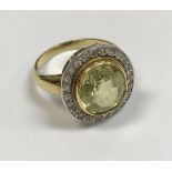 An 18 carat gold set ladies dress ring, the central peridot approx 6 carats,