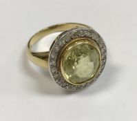 An 18 carat gold set ladies dress ring, the central peridot approx 6 carats,