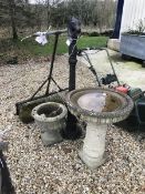 A pair of composite stone garden urns, together with a similar bird bath,