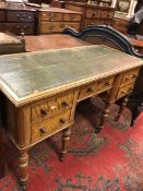 A late Victorian satin walnut desk the tooled and gilded leather insert top within a moulded edge