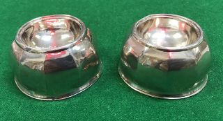 A pair of Queen Anne trencher salts of faceted circular form raised on a splayed foot (by Joseph