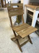 A set of four slatted teak folding garden chairs