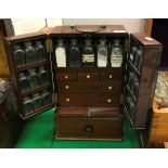 A Victorian mahogany apothecary's cabinet with brass swan-necked handle,