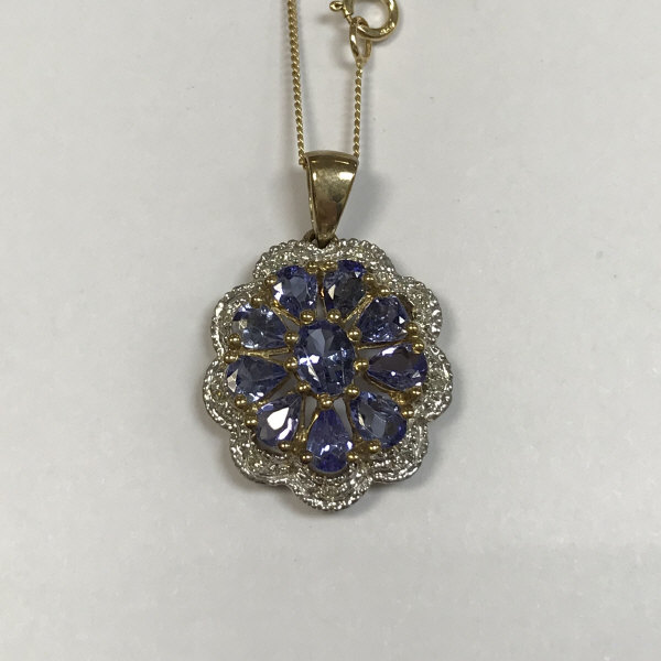 A 9ct gold diamond and blue topaz pendant