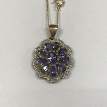 A 9ct gold diamond and blue topaz pendant