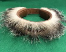 An early to mid 20th Century red leather dog collar, mounted with badger fur,