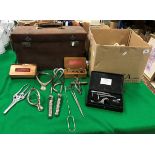 A leather-covered case containing various medical equipment/tools,