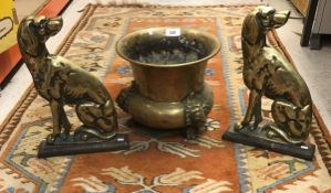 A pair of Victorian brass doorstops as landseer dogs and a brass jardiniere with grotesque mask