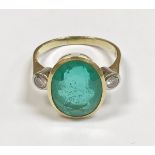 A ladies gold dress ring set with central oval cut emerald, approx 4.
