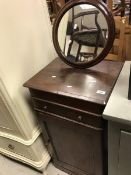 A Victorian mahogany gentleman's shaving stand with circular mirror over a two part rising top and