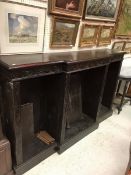 A Victorian ebonised oak breakfront bookcase with half carved Gothic style decoration