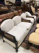 A circa 1900 Bergere two seat sofa together with two matching armchairs