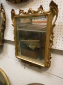A 19th Century giltwood framed mirror with scrollwork decoration