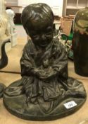 A Japanese Meiji period verdigris patinated bronze figure of a seated child with doll