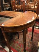 A modern burr walnut and cross banded demi-lune table in the Georgian taste