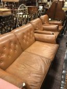 A circa 1900 brown leather upholstered two seat soft on square tapered legs to castors together