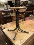A 19th Century wrought iron wooden seated revolving stool of unusual splayed quadruped design