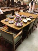 A Gordon Russell of Broadway teak extending dining table with a set of eight chairs