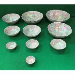 A graduated set of ten late 20th Century Chinese Gingdezhen polychrome decorated bowls bearing faux