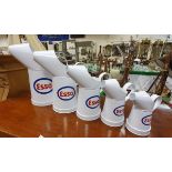 A graduated set of five modern Esso oil cans