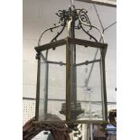 A lacquered brass-framed hexagonal glazed hanging lantern,