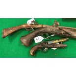 An 18th or early 19th Century flintlock pistol with walnut stock the metal work engraved "M.SE....