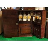 A Victorian mahogany apothecary's cabinet the two doors each fitted with eight bottle compartments