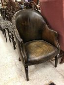 An early 20th Century leather upholstered tub chair with stud decoration CONDITION