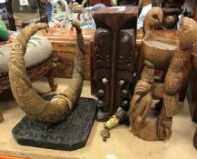 A South Seas carved hardwood totem as four facing heads with shell eyes,