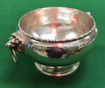 A George V silver pedestal bowl with beaded rim and heavy cast lion mask ring handles raised on a