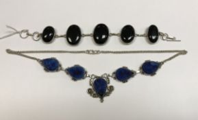 A black onyx and silver mounted bracelet and a blue stone geode style white metal mounted necklace