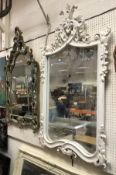A modern Rococo style white painted framed wall mirror in the Louis XV taste together with a modern