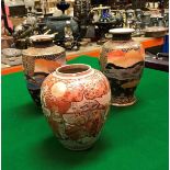 A pair of Japanese Satsuma vases, a single ginger jar (no cover), two Netsukes of seated men,