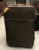 A modern Louis Vuitton travel case with pull out handle and casters CONDITION REPORTS