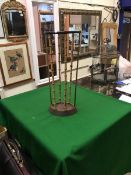 A 19th Century treen ware boot jack and a bamboo and brass and iron stick stand by Artis of