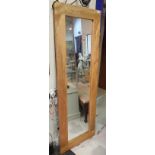 A modern rectangular oak framed mirror together with a Victorian pine pot cupboard