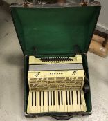 A Hohner Verdi II simulated mother of pearl veneered piano accordion with case