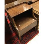 An early 19th Century mahogany night table with rising top over a box base on square tapered legs