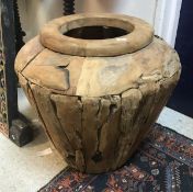 A modern teak urn