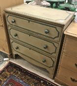 An early 19th Century painted pine chest of three long drawers raised on bracket feet
