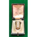 A 14 carat gold thimble in Goldsmiths and Silversmiths box, the thimble inscribed "Rev. M.