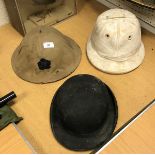 A collection of various hats including tropical pith helmet, Herbert Johnson bowler,