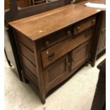 An oak chest of two short drawers over one long over two cupboard doors and an oak gate leg table