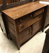 An oak chest of two short drawers over one long over two cupboard doors and an oak gate leg table