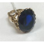 A nine carat gold blue stone set dress ring