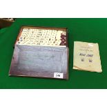 A Chinese bone and bamboo mahjong set with book of "Sandard rules for the Chinese domino game of