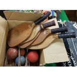 A box containing vintage croquet hoops,