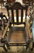 A Victorian carved oak framed open arm hall chair with panelled seat and a 19th Century oak drop